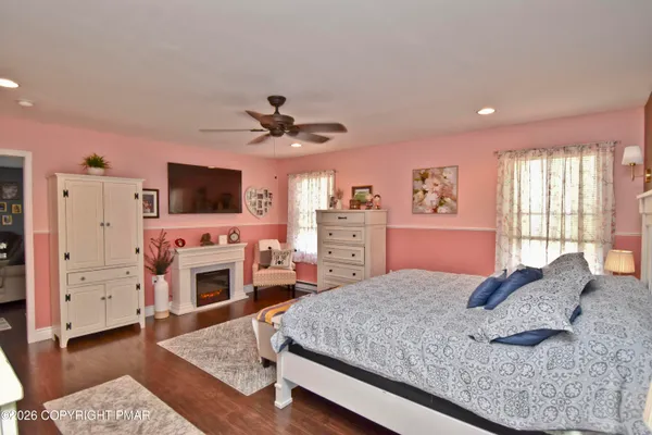 a bedroom with a large bed and a flat screen tv
