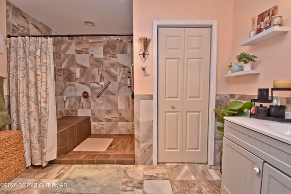 a bathroom with a shower and a sink
