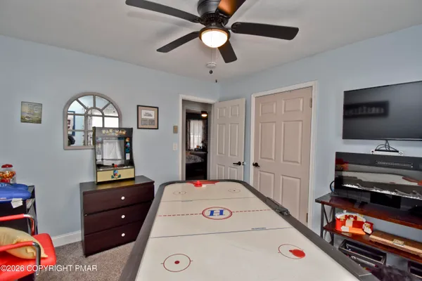 a living room filled with furniture and a flat screen tv