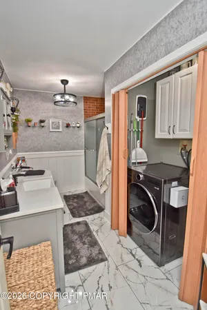 a living room with furniture kitchen view and a flat screen tv