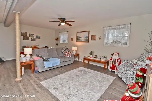 a kitchen with white cabinets and window