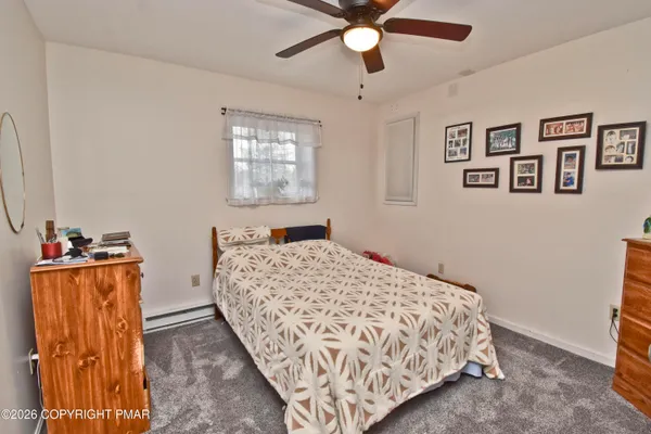 a bedroom with a bed and a dresser