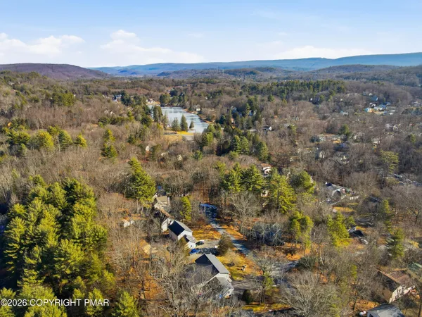 an aerial view of a house with a yard