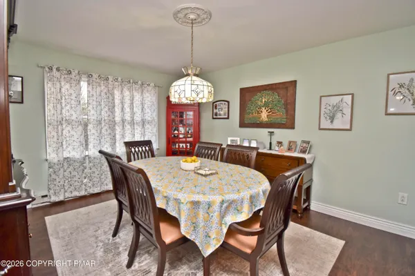 a view of a dining room with furniture window and wooden floor