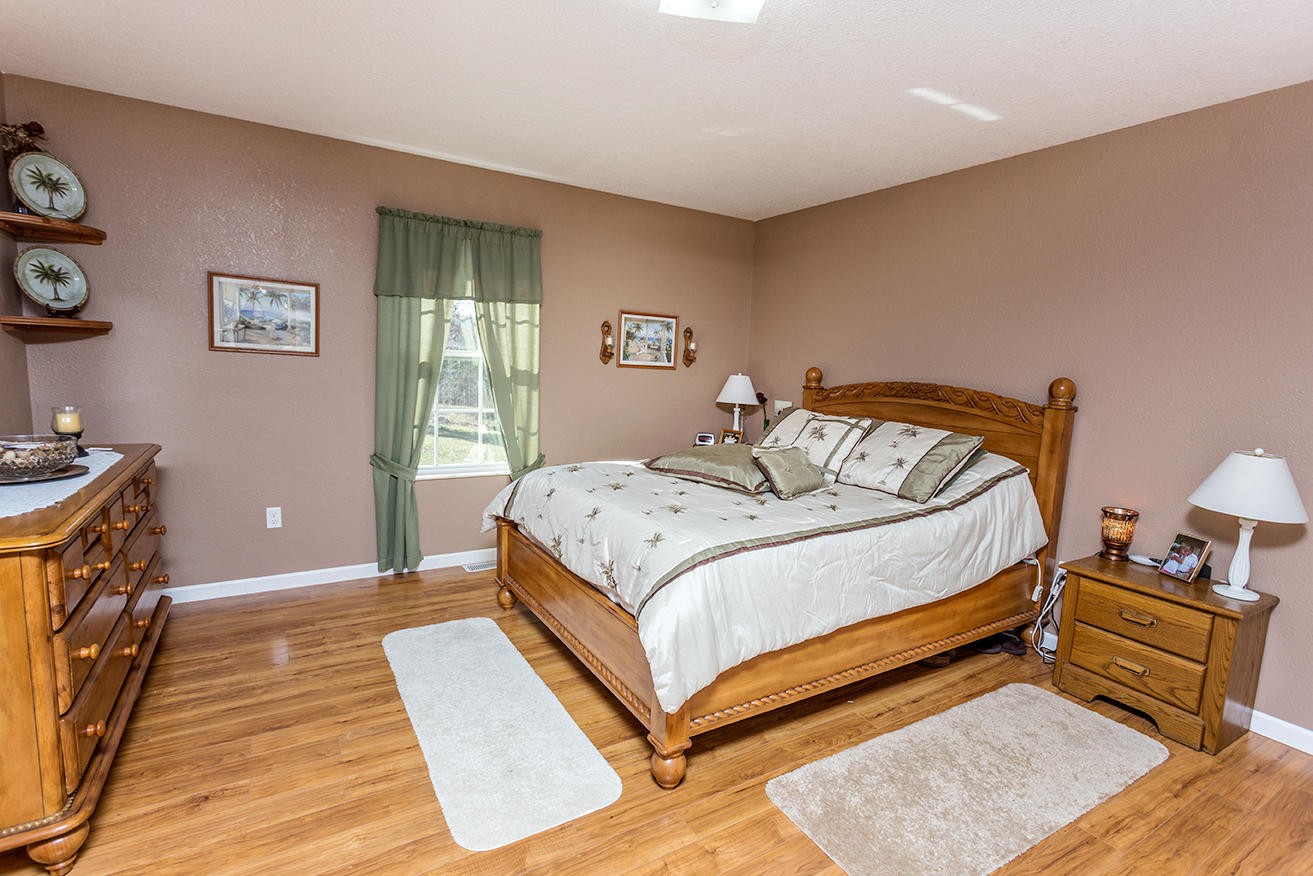 4799 Ross Road Philadelphia, TN 37846 - Photo 13 of 31 a bedroom with a bed and wooden floor