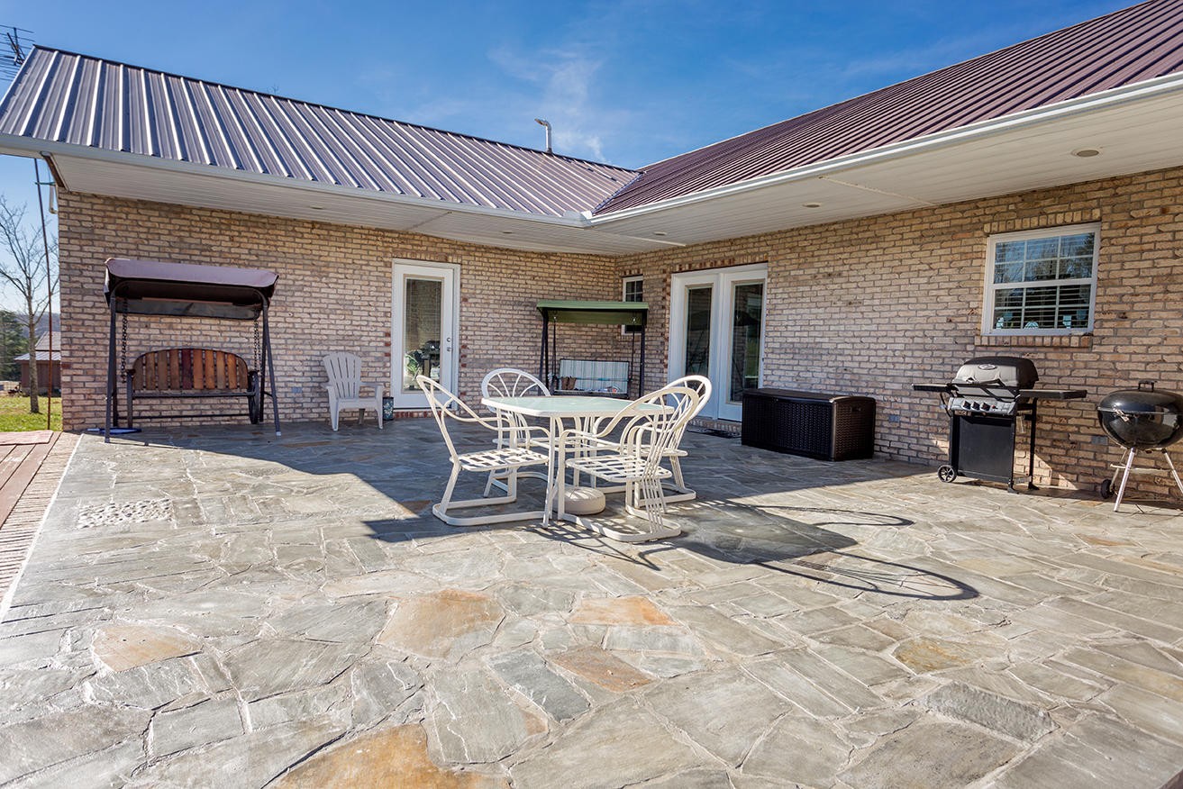 4799 Ross Road Philadelphia, TN 37846 - Photo 24 of 31 a view of a patio with table and chairs and potted plants