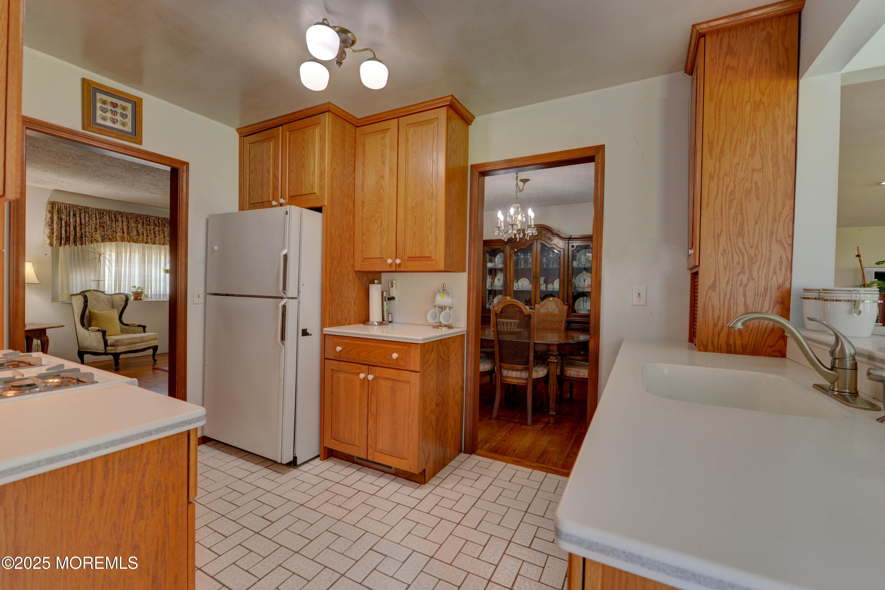 26 Old Manor Road Holmdel, NJ 07733 - Photo 15 of 37 a kitchen with refrigerator a microwave a dining table and chairs