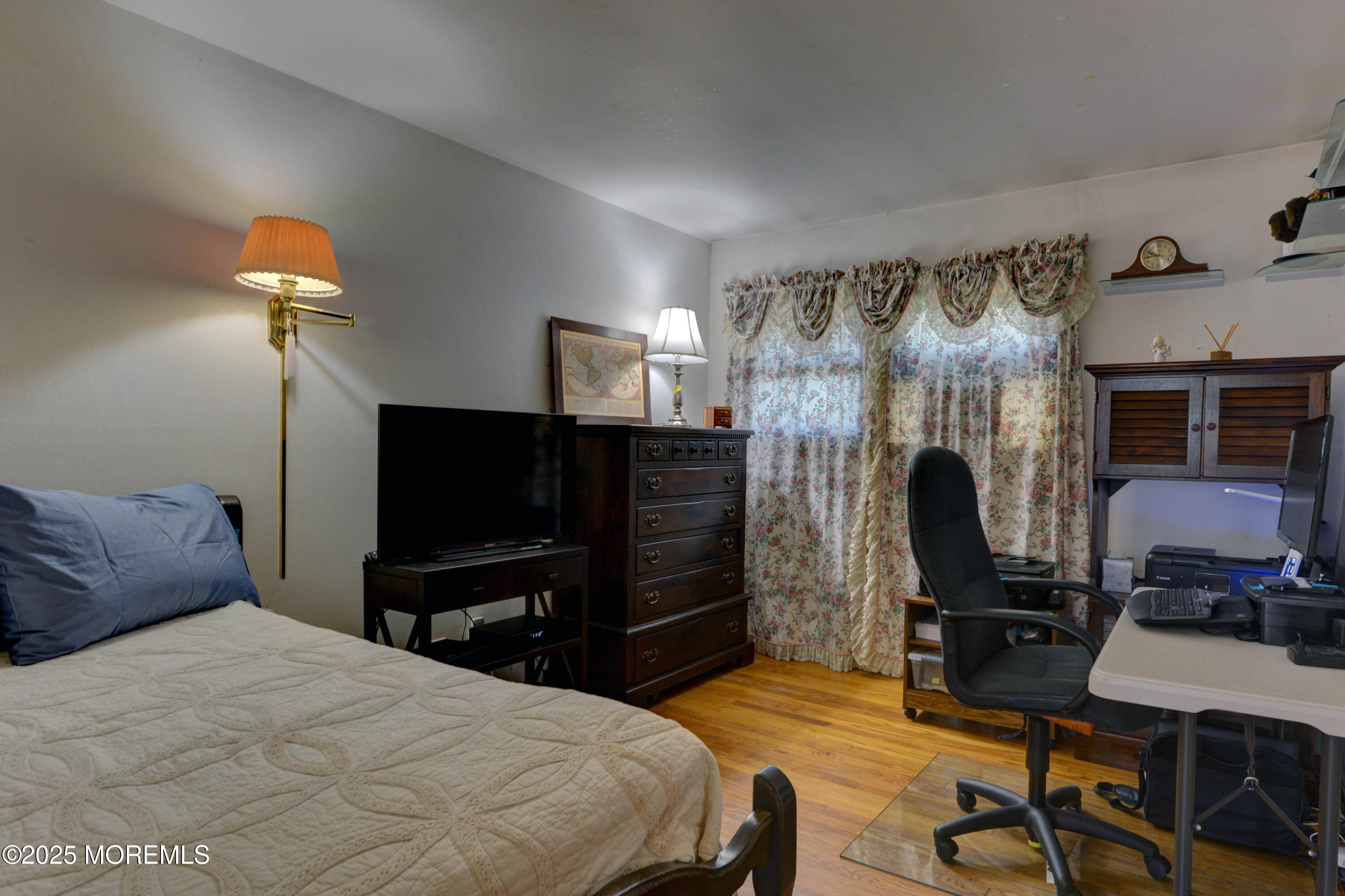 26 Old Manor Road Holmdel, NJ 07733 - Photo 18 of 37 a bedroom with a bed and a flat tv screen on dresser
