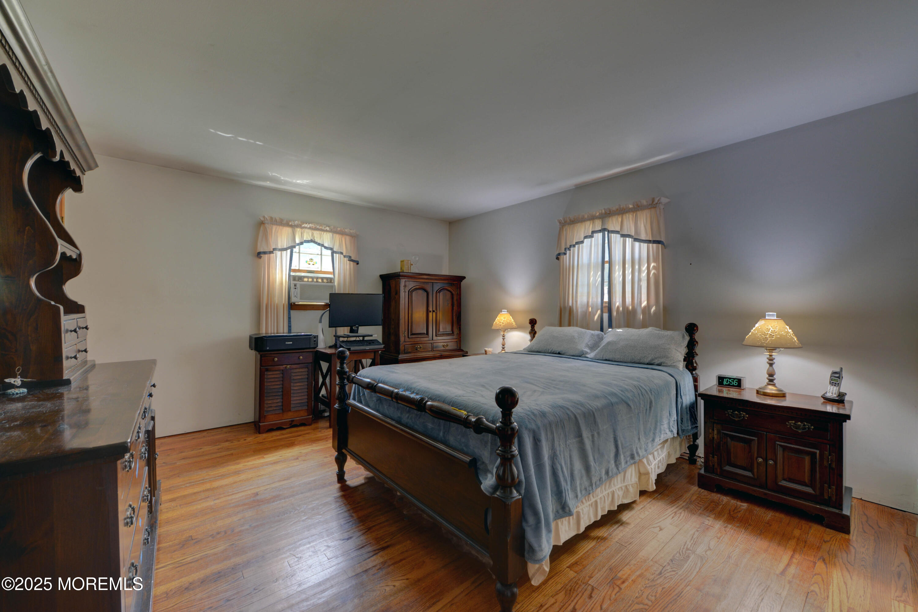 26 Old Manor Road Holmdel, NJ 07733 - Photo 22 of 37 a spacious bedroom with a bed a dresser and wooden floor