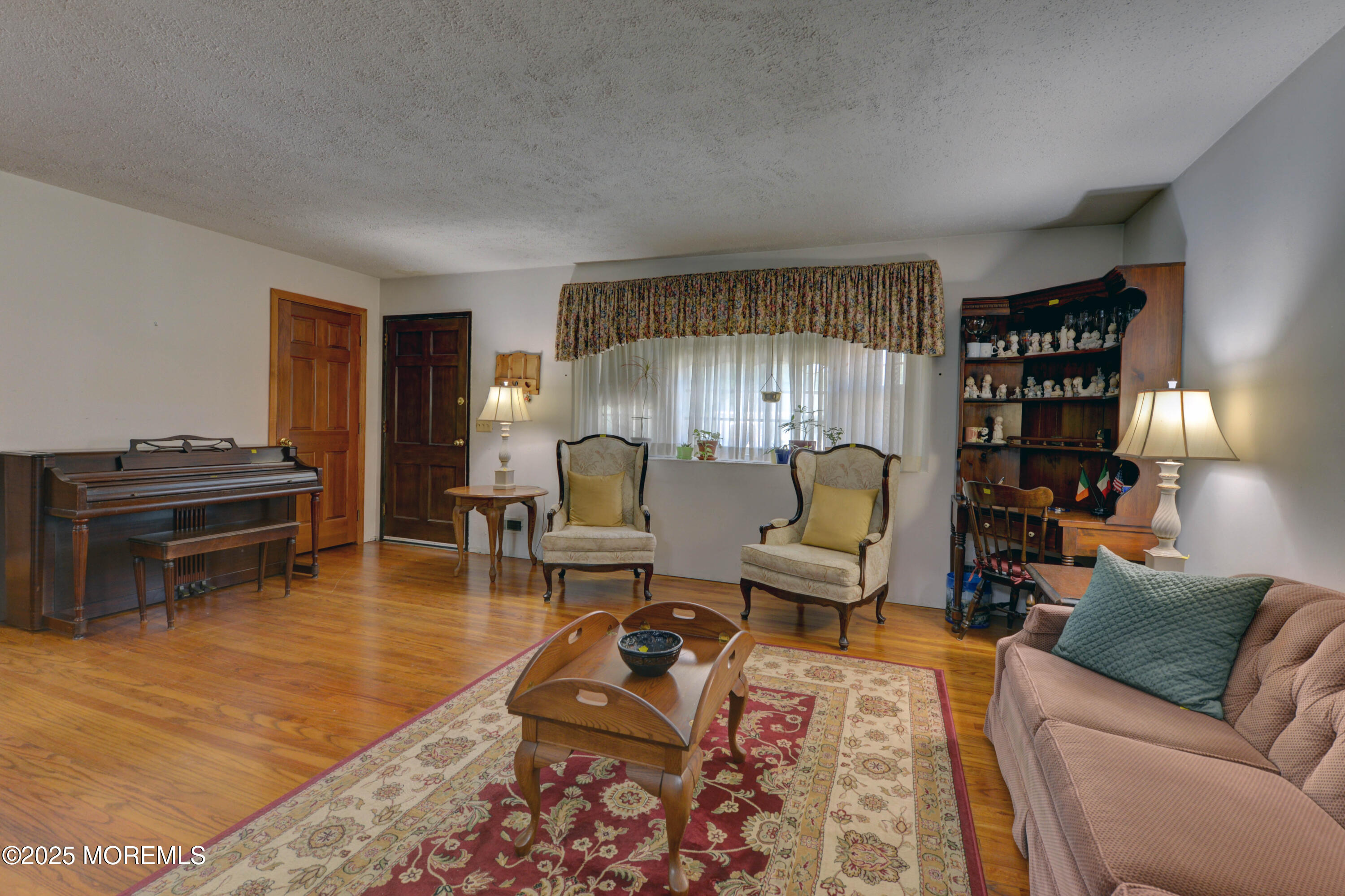 26 Old Manor Road Holmdel, NJ 07733 - Photo 3 of 37 a living room with furniture and a piano