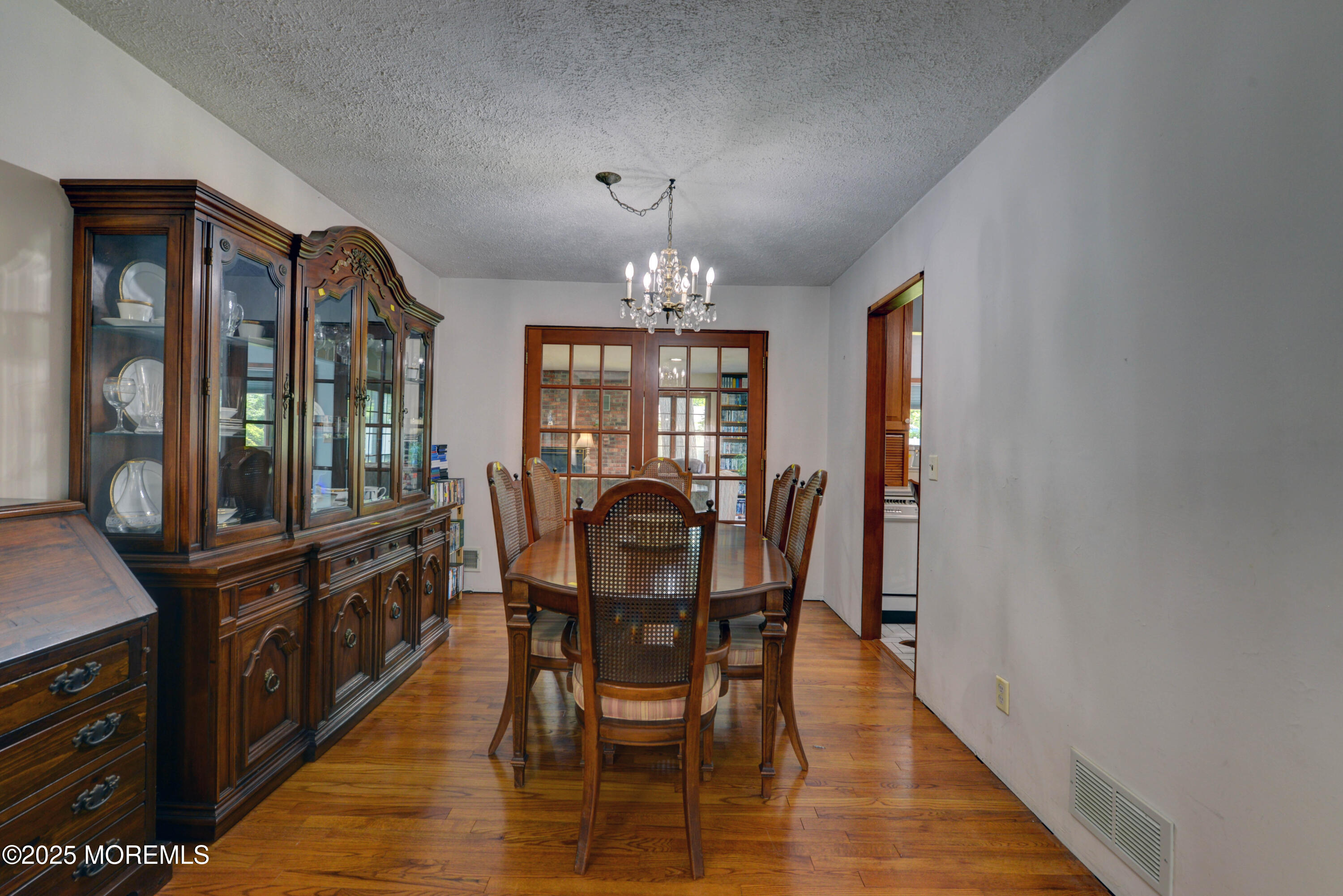 26 Old Manor Road Holmdel, NJ 07733 - Photo 5 of 37 a view of a dining room with furniture a chandelier and wooden floor