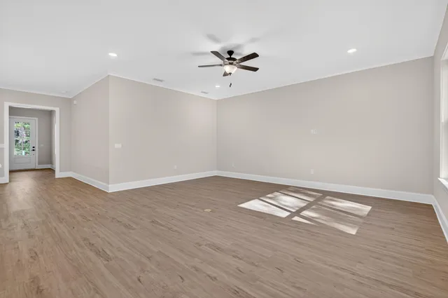 a kitchen with stainless steel appliances granite countertop a sink a stove and a wooden floors