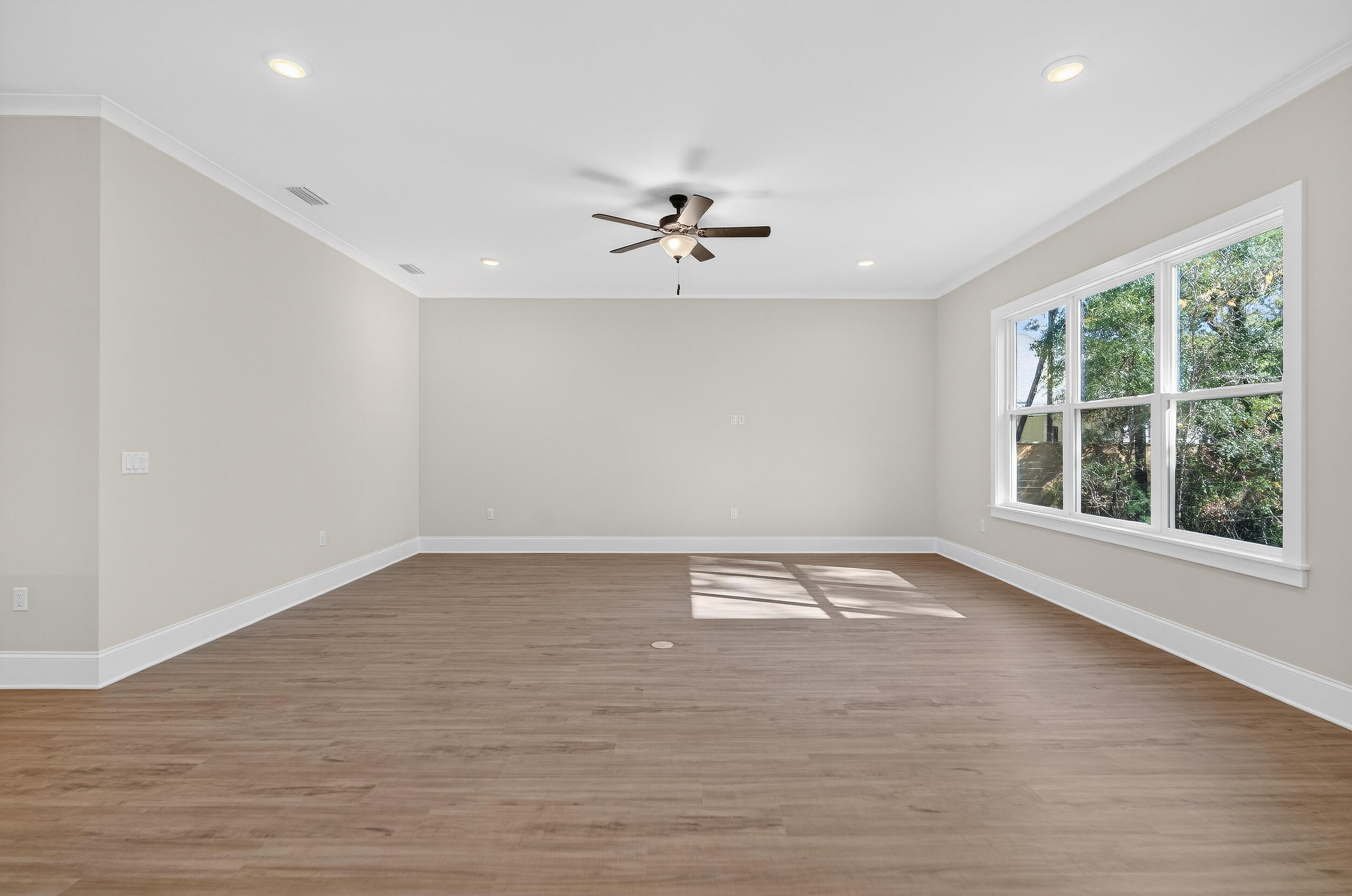 397 North J Hunter's Way, Unit LOT 36 Freeport, FL 32439 - Photo 13 of 54 an empty room with wooden floor and windows