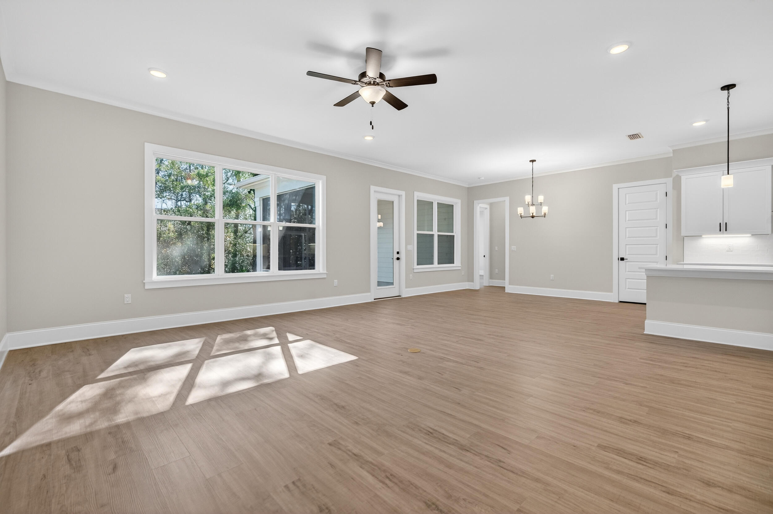 397 North J Hunter's Way, Unit LOT 36 Freeport, FL 32439 - Photo 15 of 54 a view of an empty room with a window and wooden floor