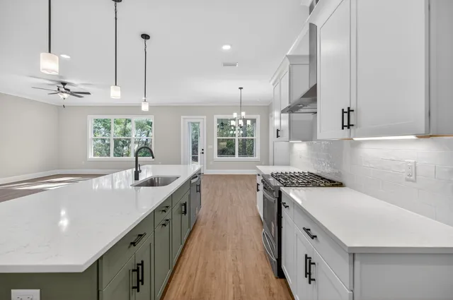 a view of an empty room with window and cabinet