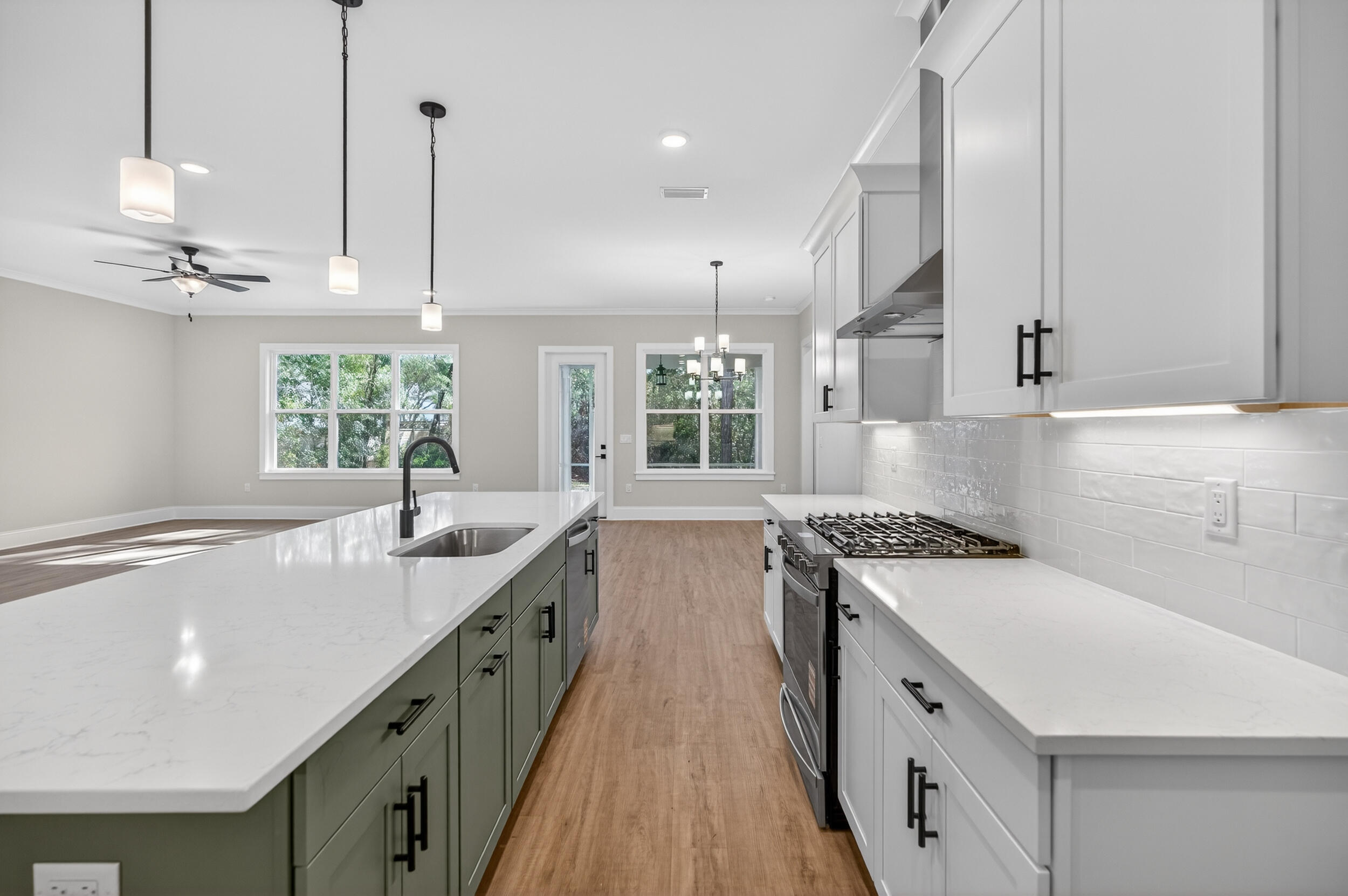 397 North J Hunter's Way, Unit LOT 36 Freeport, FL 32439 - Photo 18 of 54 a kitchen with stainless steel appliances granite countertop a sink a stove and a wooden floors