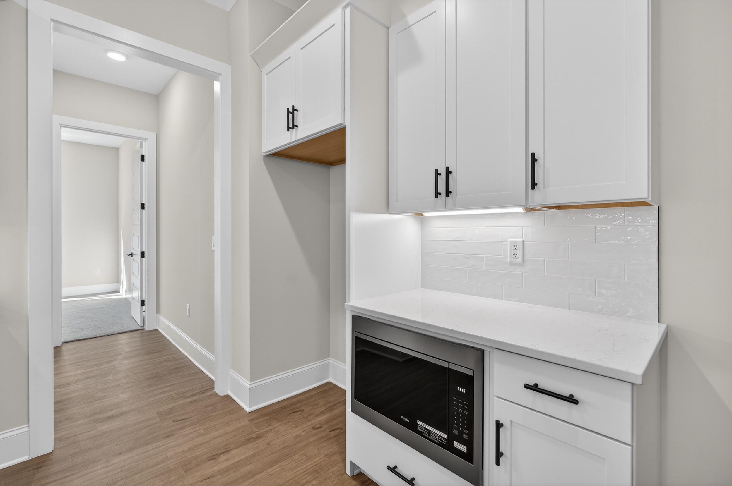 397 North J Hunter's Way, Unit LOT 36 Freeport, FL 32439 - Photo 19 of 54 a view of an empty room with wooden floor and a ceiling fan