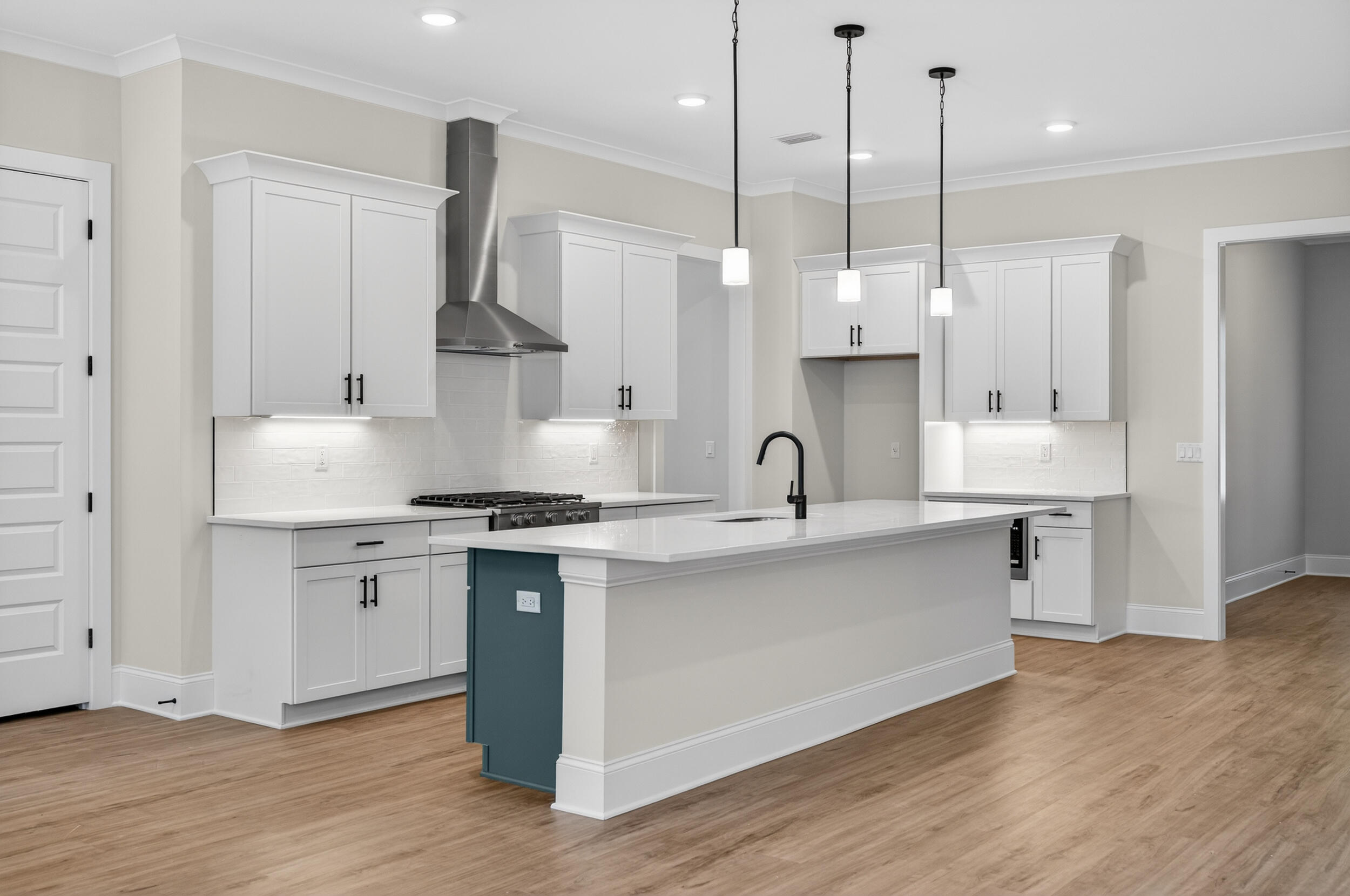 397 North J Hunter's Way, Unit LOT 36 Freeport, FL 32439 - Photo 22 of 54 a kitchen with stainless steel appliances granite countertop a sink a stove a refrigerator and white cabinets with wooden floor