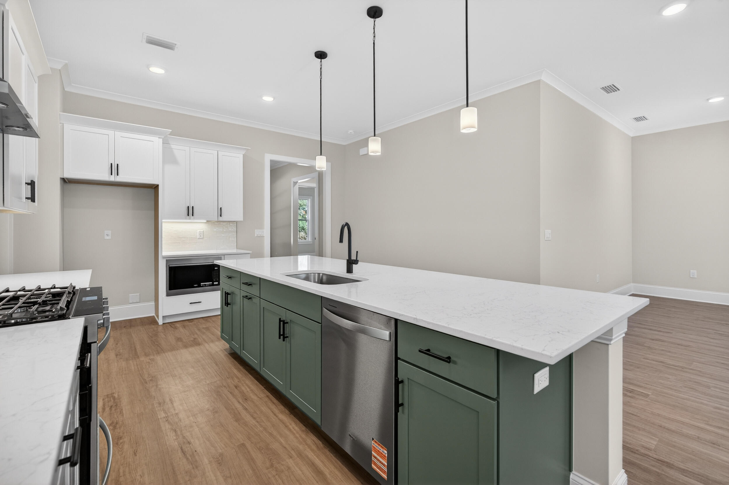 397 North J Hunter's Way, Unit LOT 36 Freeport, FL 32439 - Photo 23 of 54 a kitchen with a sink a stove a refrigerator and white cabinets