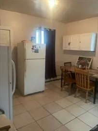 a kitchen with stainless steel appliances a refrigerator and a stove top oven