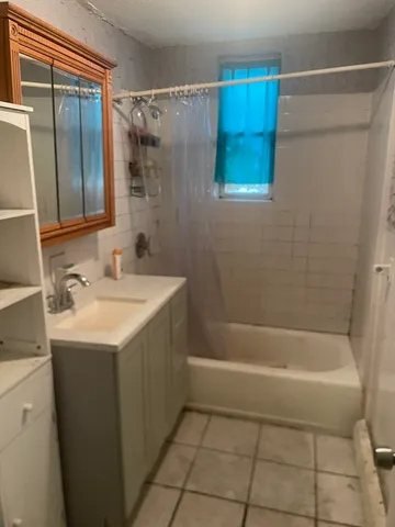 a bathroom with a sink a mirror and a bathtub
