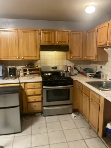 a kitchen with a stove a sink and a refrigerator