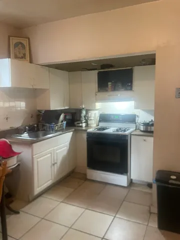 a kitchen with granite countertop a sink and a stove top oven