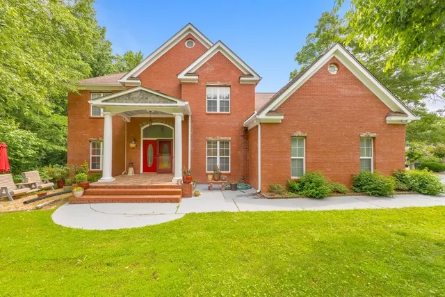 a front view of a house with a yard