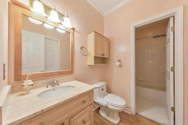 a bathroom with a granite countertop sink mirror and a bath tub