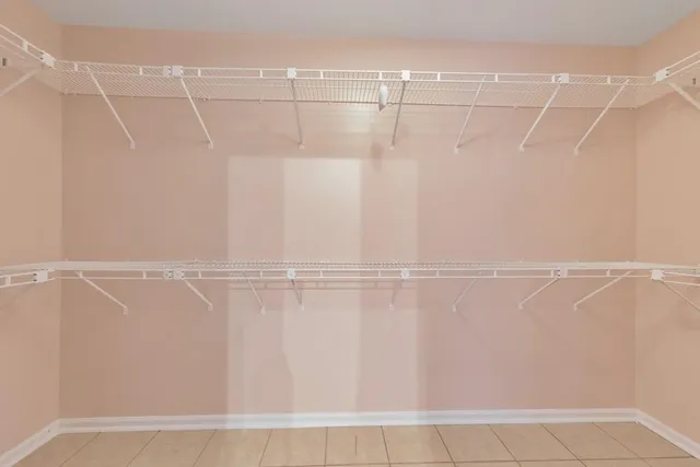 a view of staircase with lots of frames and white walls