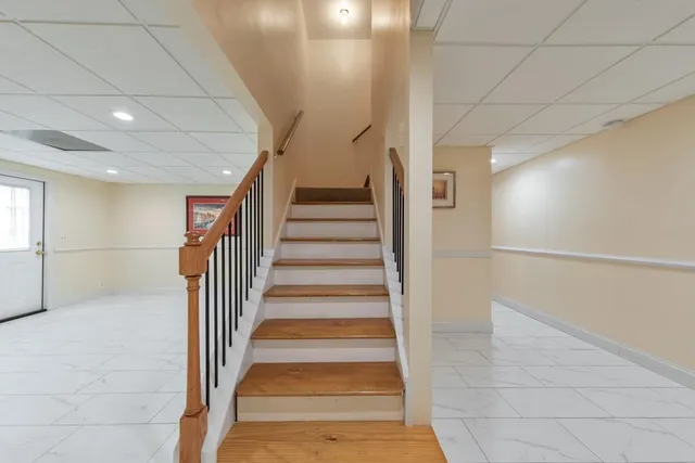 an aerial view of a house with a yard and tennis court