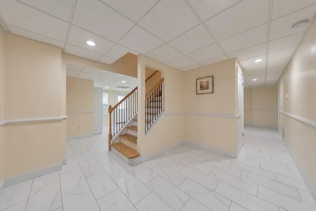 a view of a wooden house with a yard and plants