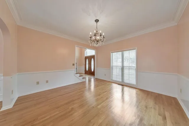 a view of a room with wooden floor and staircase