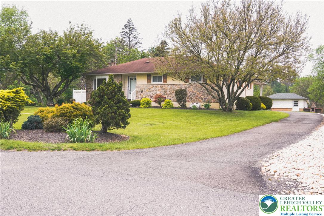 13 Craig Road Lehighton, PA 18235 - Photo 3 of 39 This charming residence features a well-maintained lawn and a convenient paved driveway.