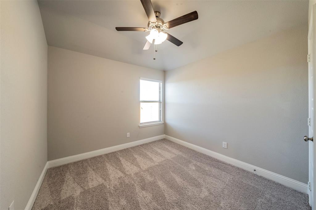 6406 Rienzi Drive Greenville, TX 75402 - Photo 11 of 26 an empty room with a window and a fan