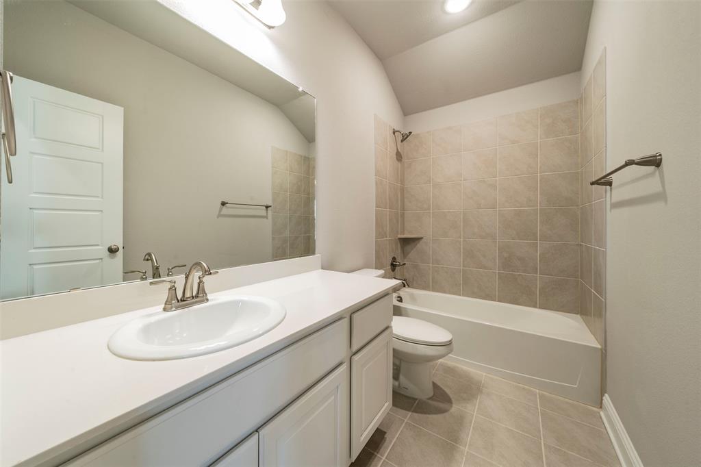6406 Rienzi Drive Greenville, TX 75402 - Photo 13 of 26 a bathroom with a sink a toilet and shower