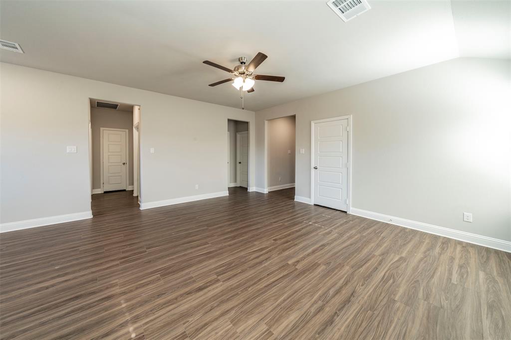 6406 Rienzi Drive Greenville, TX 75402 - Photo 19 of 26 an empty room with wooden floor and windows