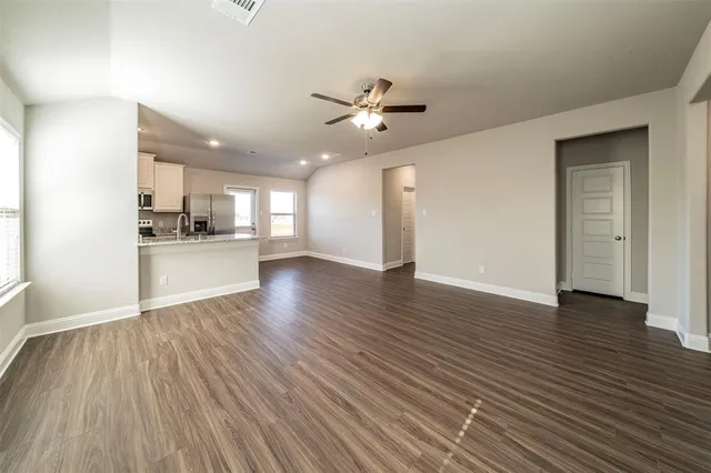 a view of a kitchen with wooden floor and a kitchen space