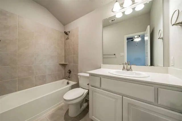 a bathroom with a sink a toilet a mirror a bathtub and shower