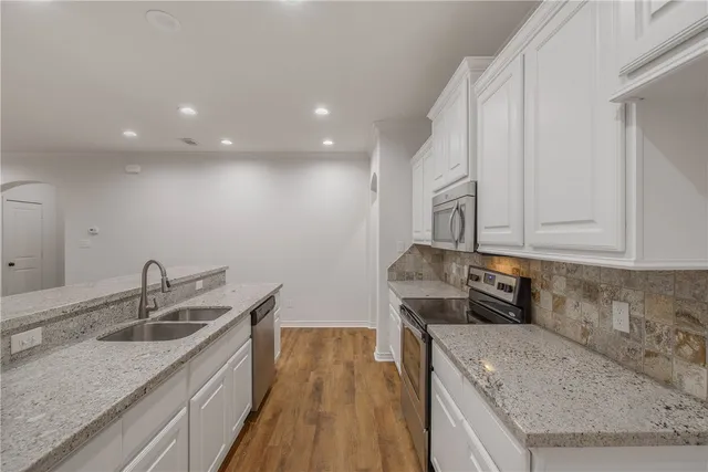 a kitchen that has a lot of cabinets in it