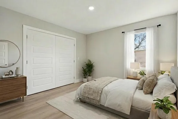 a bedroom with a bed and a painting on the wall