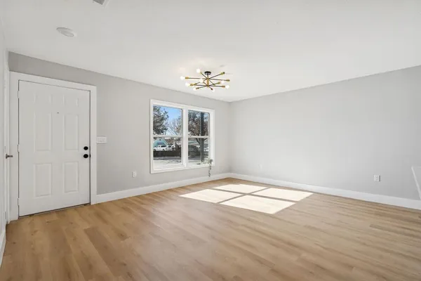 a bedroom with a bed a mirror and a dresser