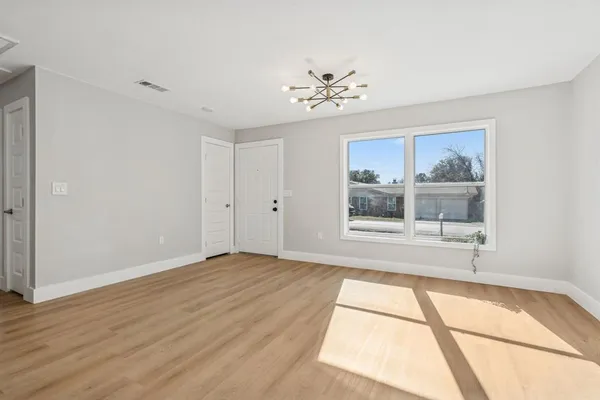 a view of kitchen with cabinets microwave and stove