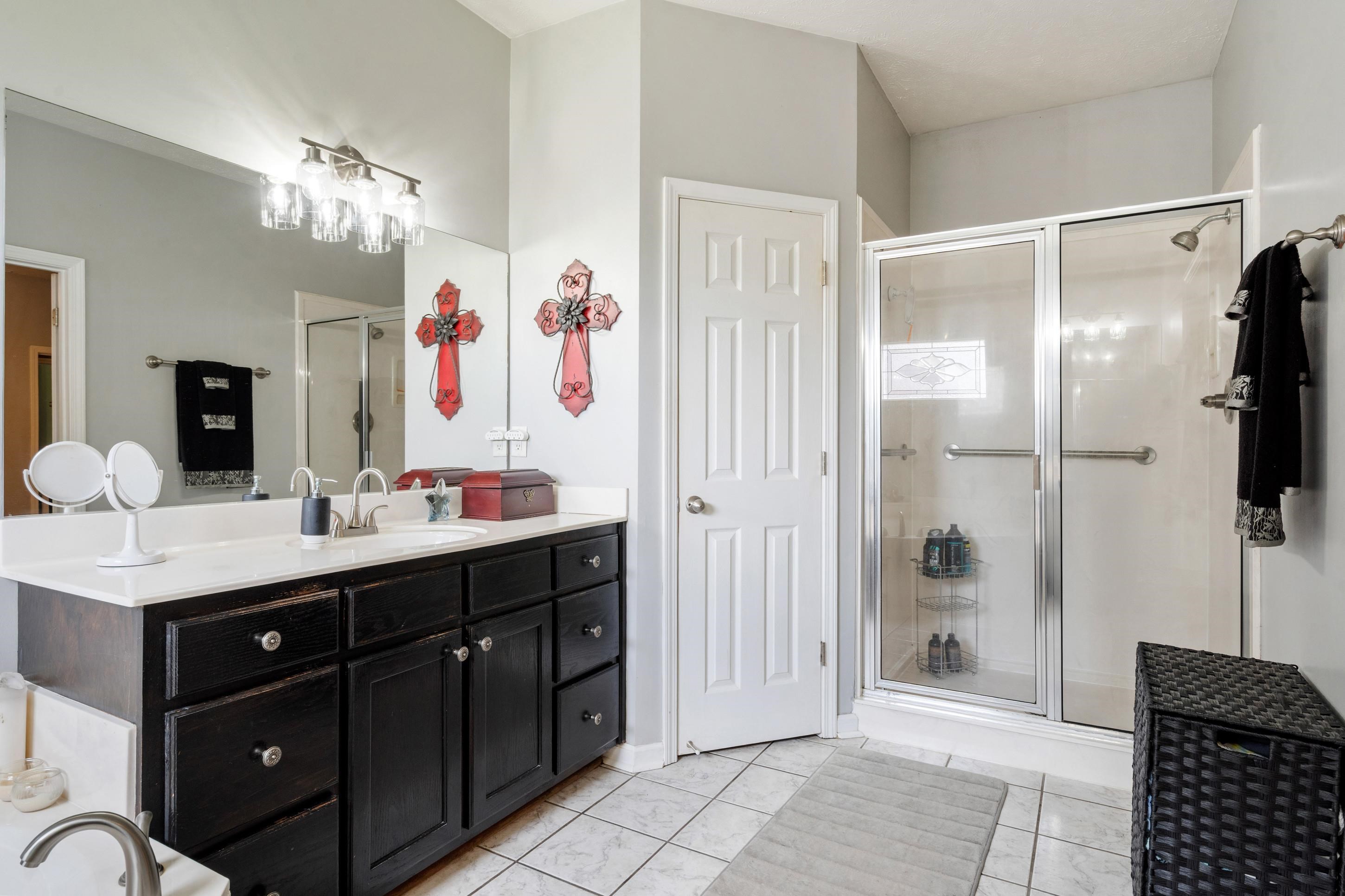 7757 Brunswick Road Millington, TN 38053 - Photo 13 of 40 Bathroom featuring a spacious double vanity with dark cabinetry and a light-colored countertop