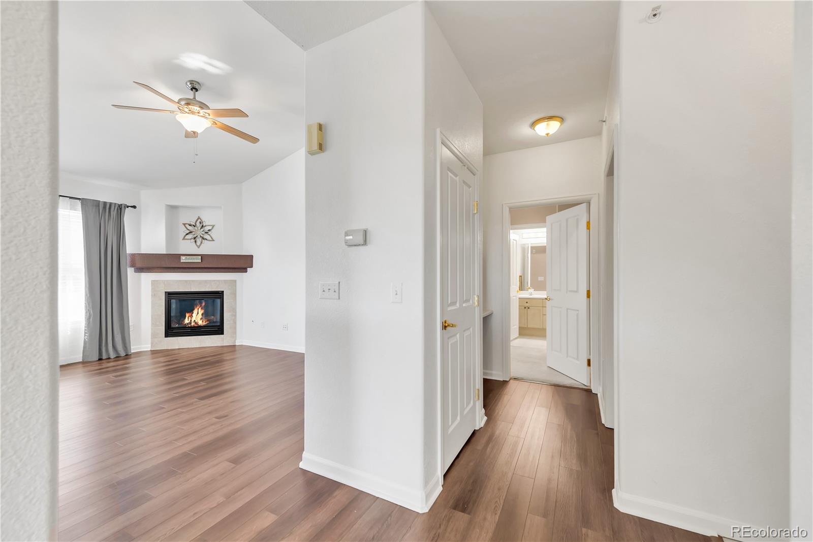 8456 South Hoyt Way, Unit 301 Littleton, CO 80128 - Photo 11 of 31 a view of a livingroom with wooden floor and a fireplace