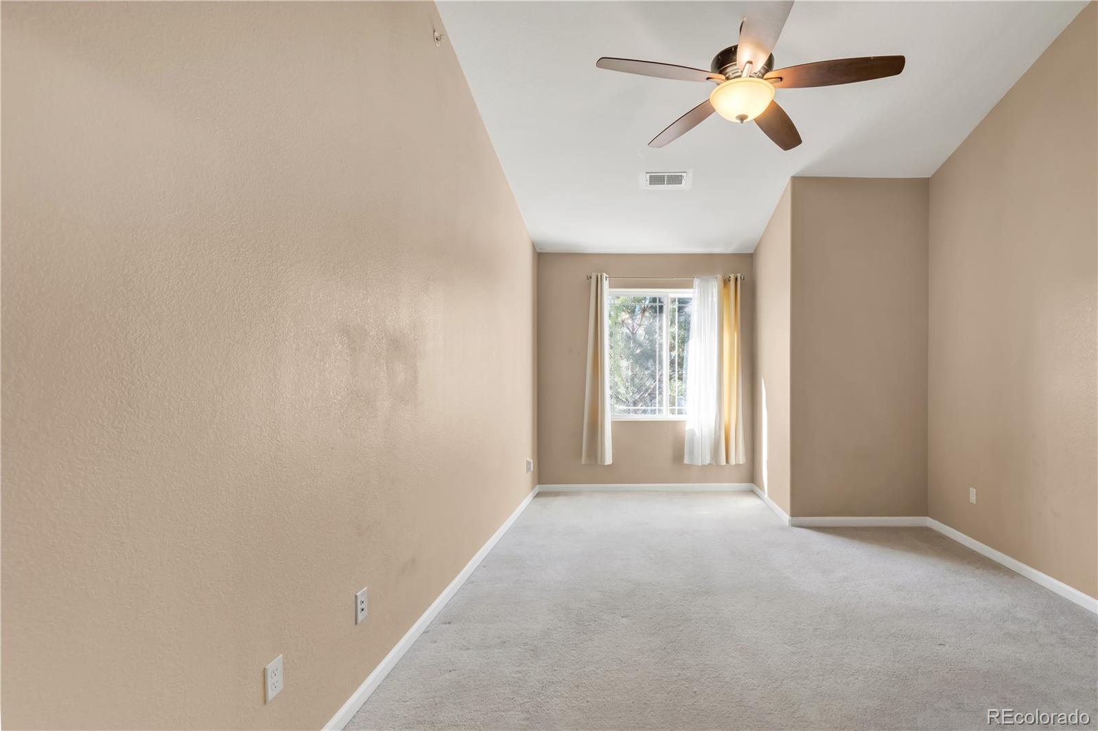 8456 South Hoyt Way, Unit 301 Littleton, CO 80128 - Photo 13 of 31 a view of a big room with a chandelier fan and windows