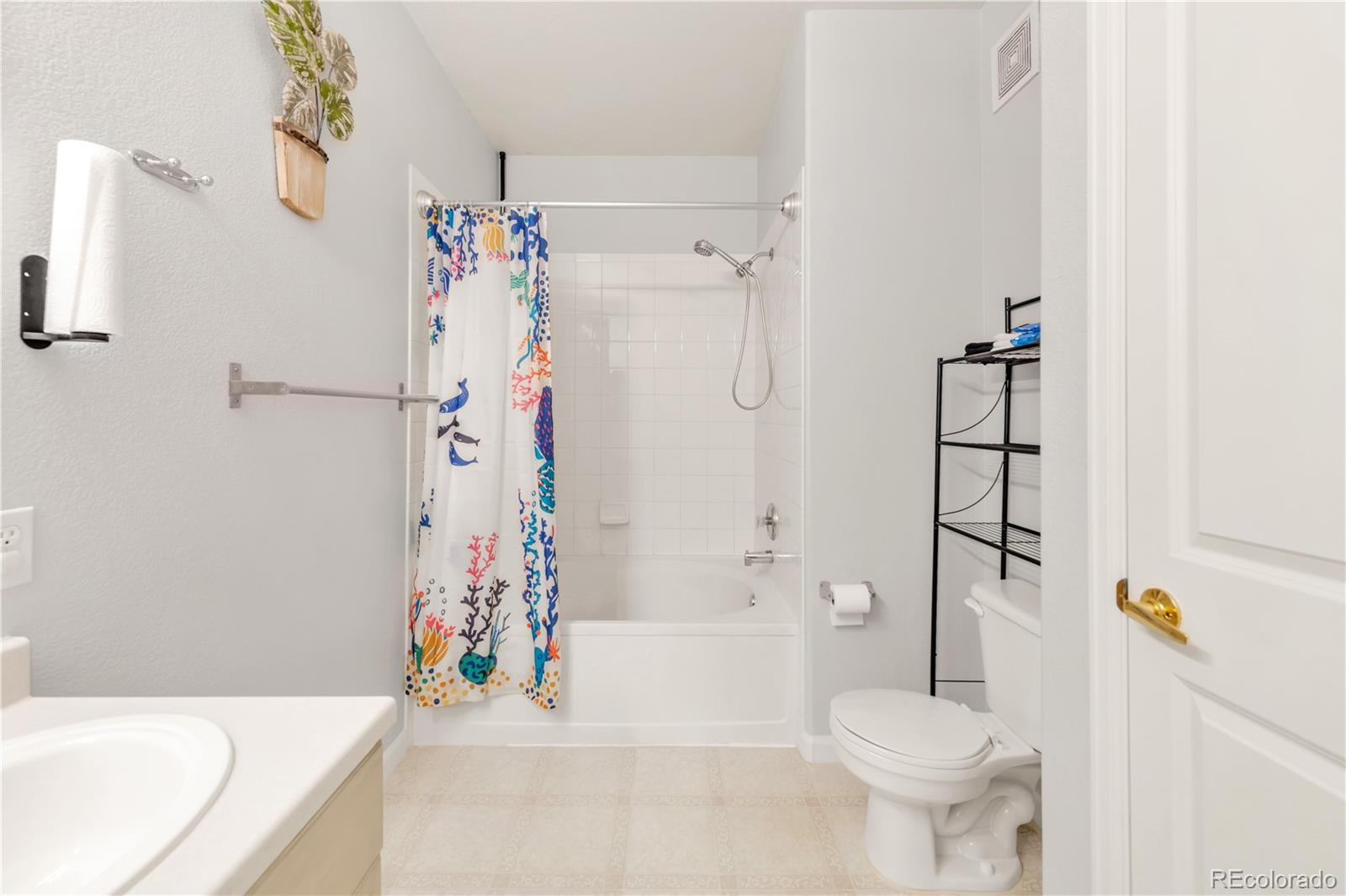 8456 South Hoyt Way, Unit 301 Littleton, CO 80128 - Photo 18 of 31 a bathroom with a bathtub a toilet and a shower