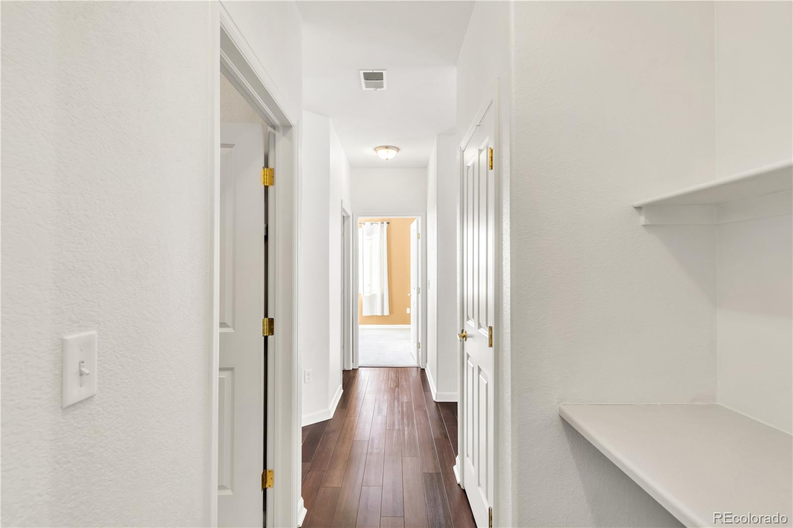 8456 South Hoyt Way, Unit 301 Littleton, CO 80128 - Photo 21 of 31 a view of a hallway with wooden floor