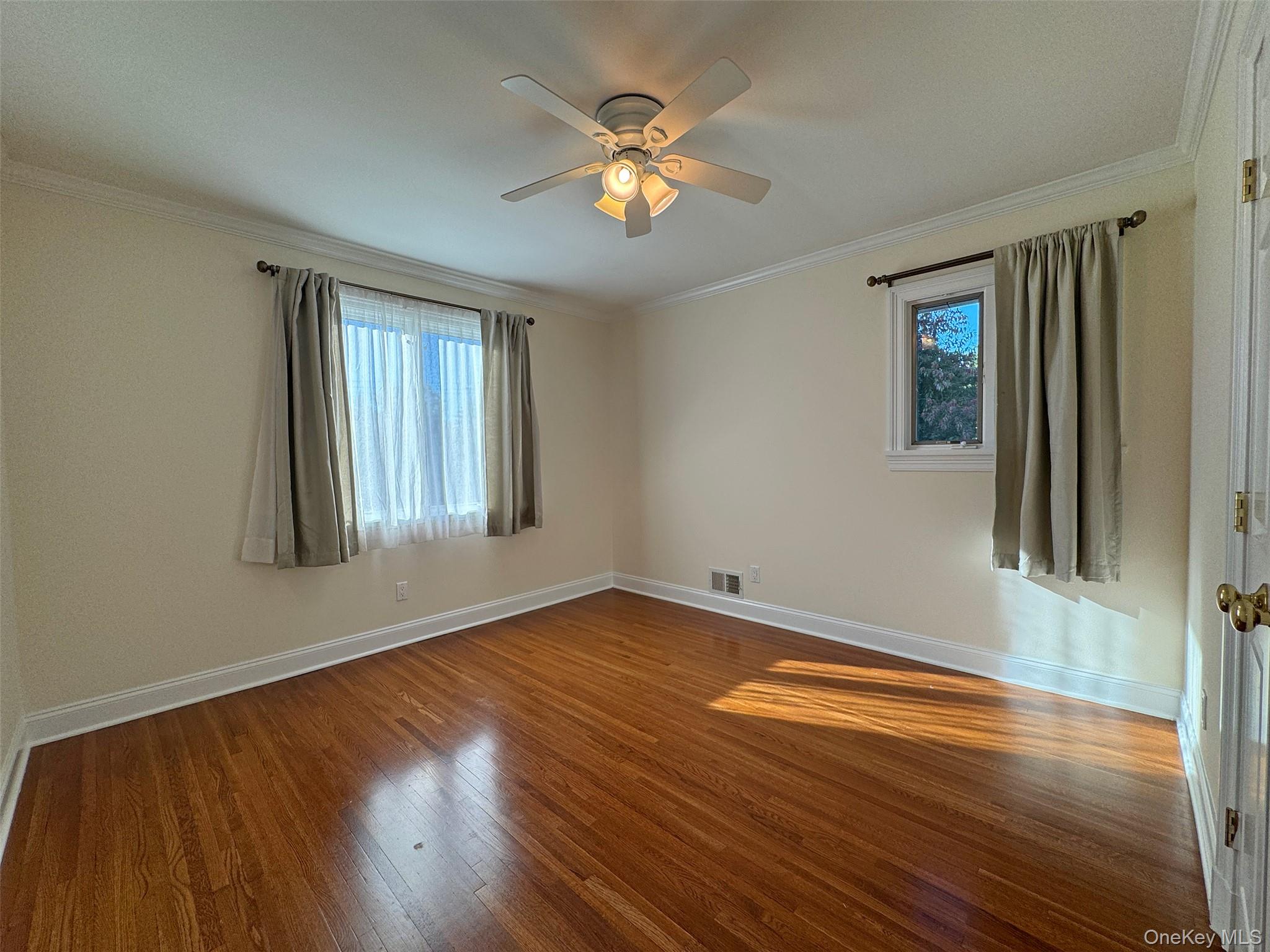 11 Country Ridge Drive Rye Brook, NY 10573 - Photo 12 of 17 wooden floor in an empty room with a window