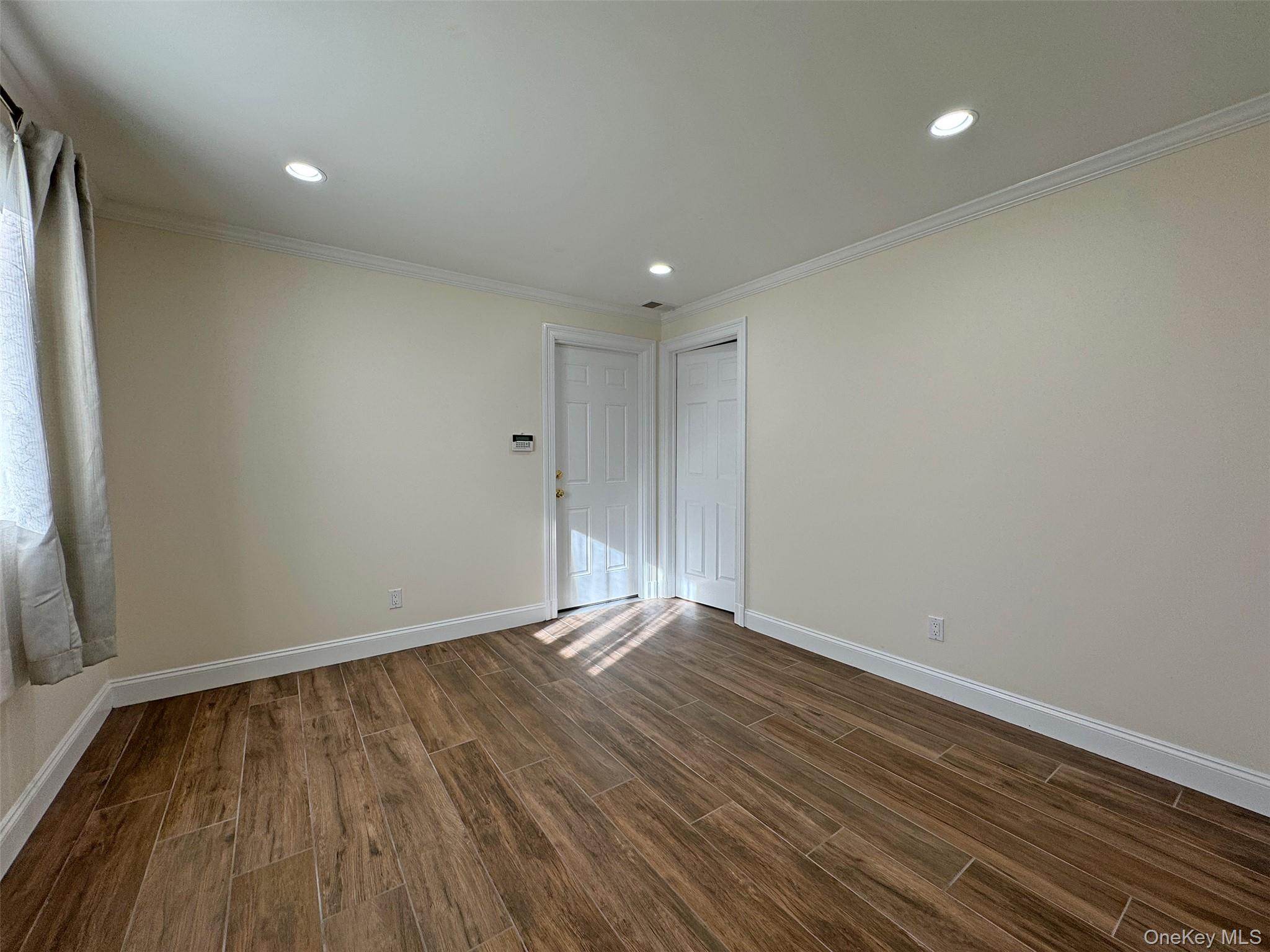 11 Country Ridge Drive Rye Brook, NY 10573 - Photo 3 of 17 a view of an empty room with wooden floor and a window